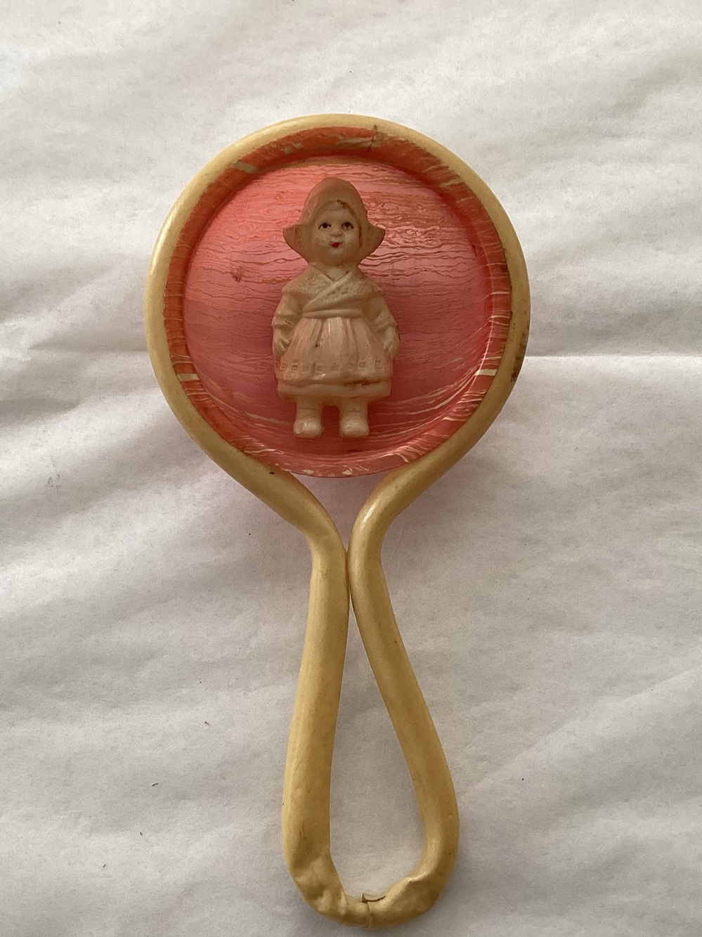 Vtg. Celluloid baby rattle featuring a molded Dutch Girl in the center of disk